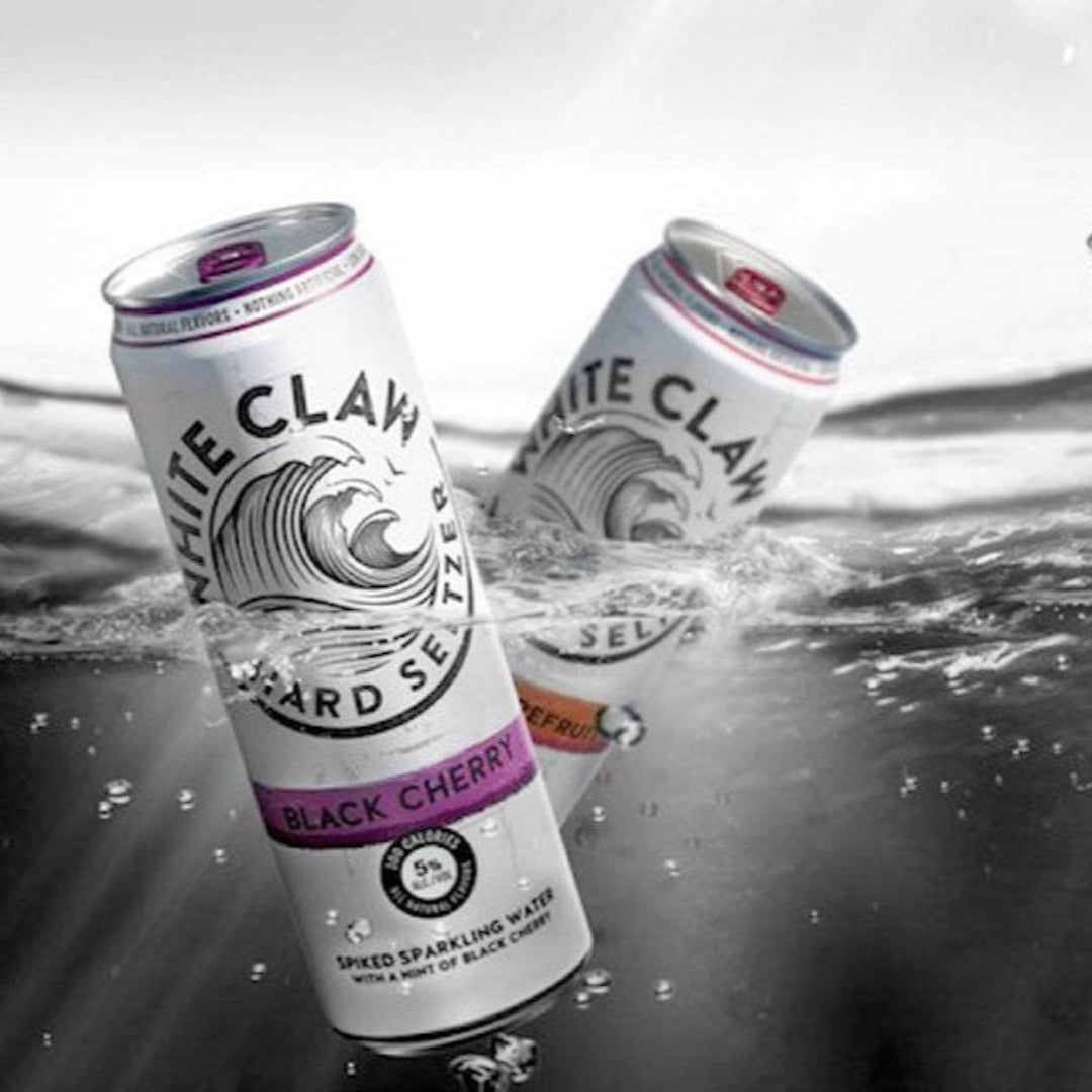 White Claw hard seltzer cans with different flavors on a water background