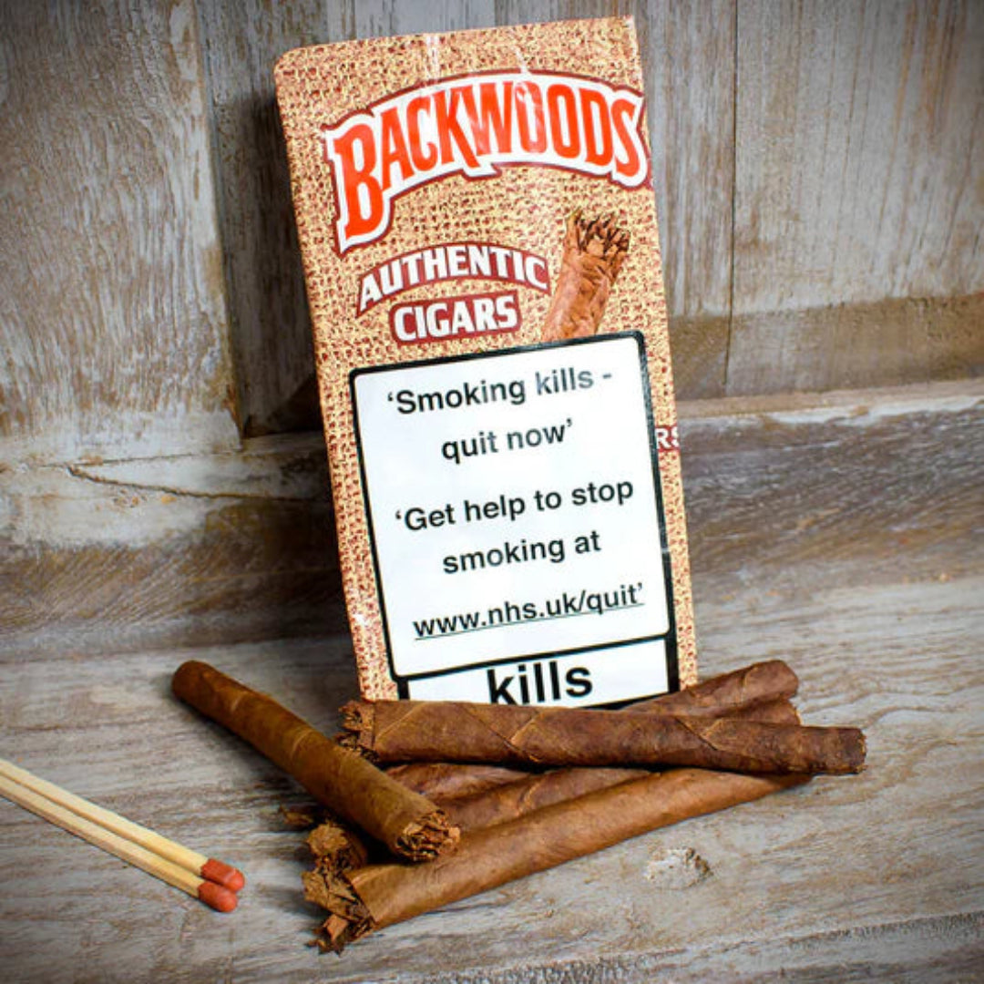 Backwoods Authentic Cigars packaging with warning label on a wooden surface