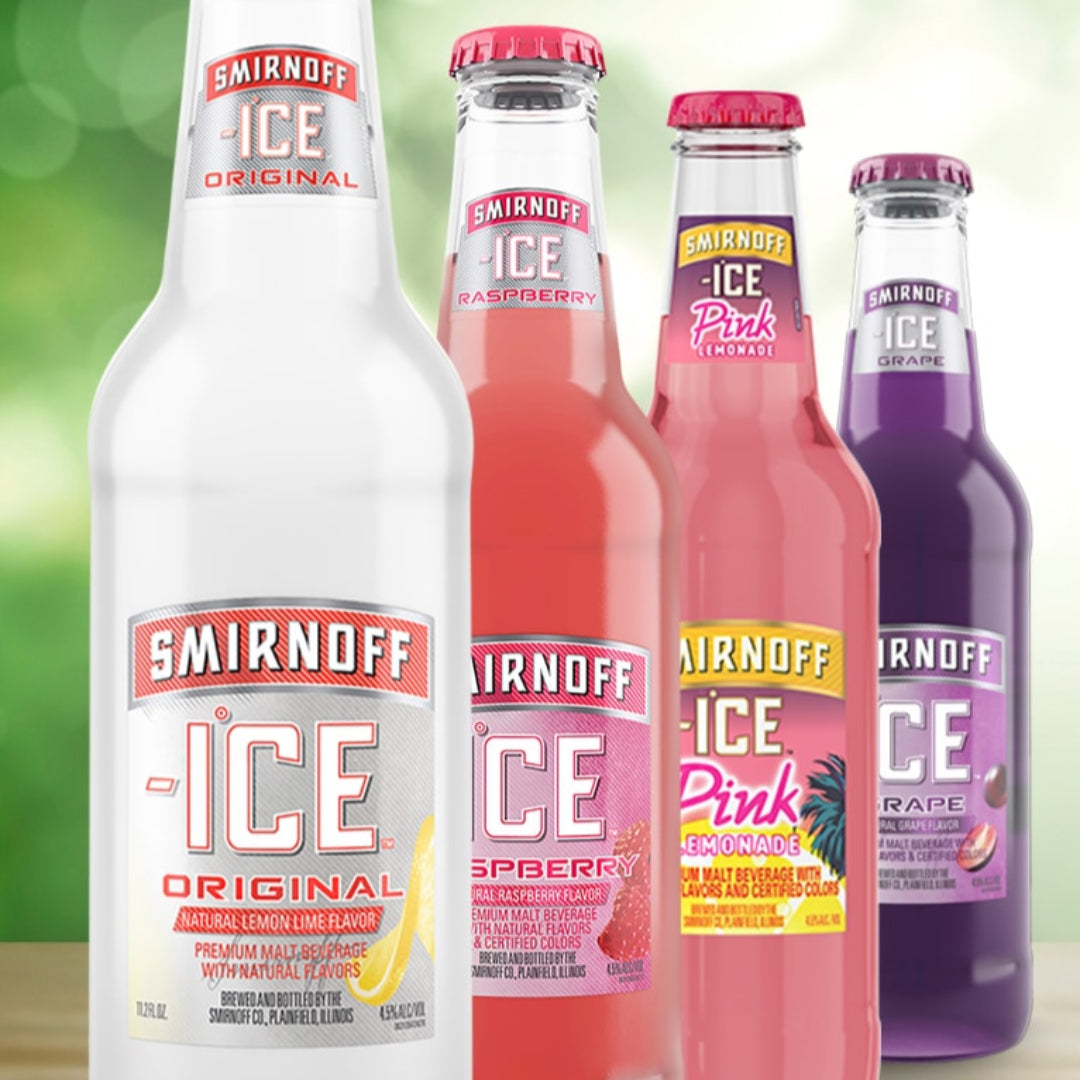 Four Smirnoff Ice bottles in different flavors on a blurred green background
