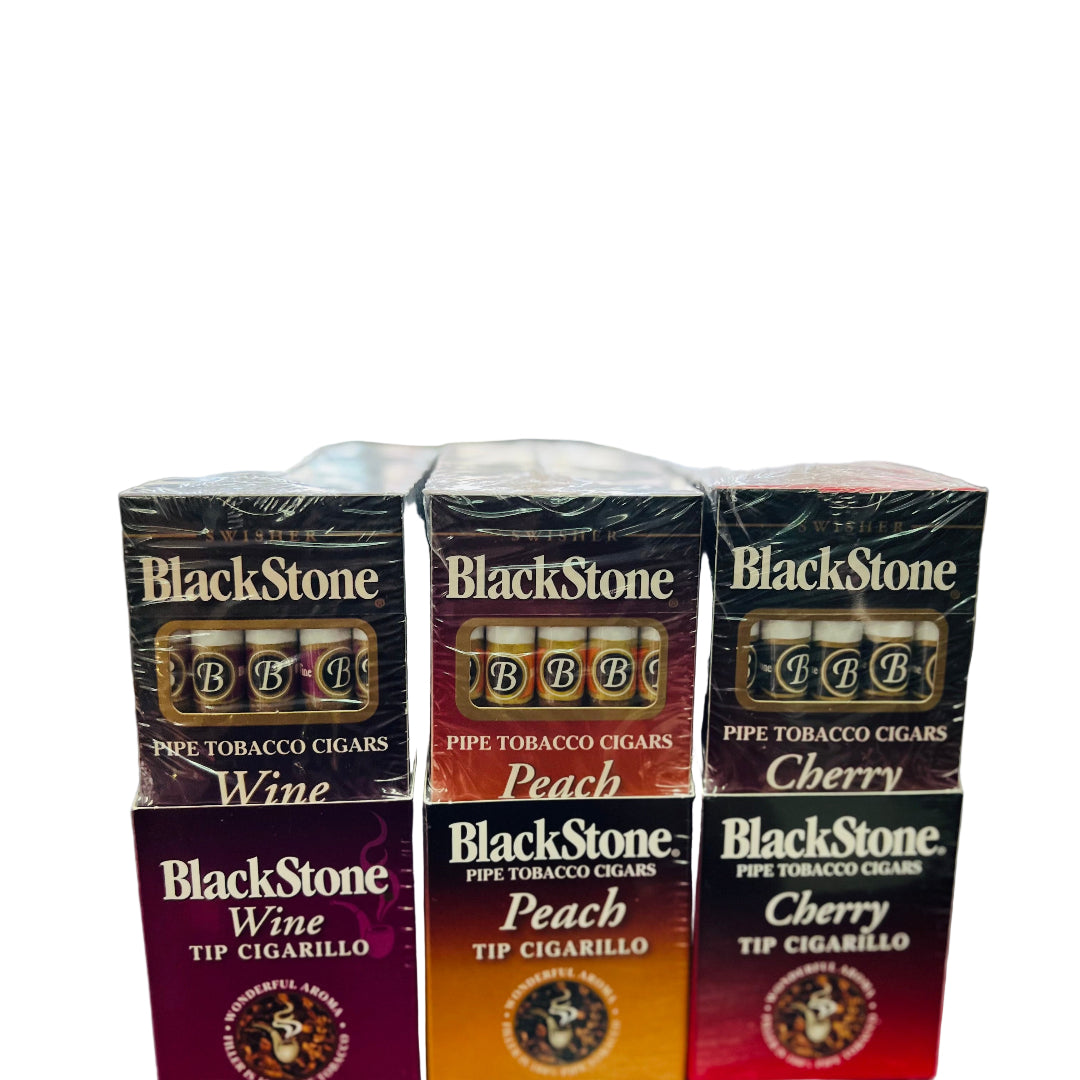 Stack of Black Stone pipe tobacco boxes in various flavors on a wooden surface.