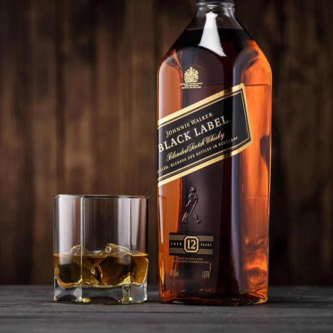 Johnnie Walker Black Label whisky bottle with a glass on a wooden surface