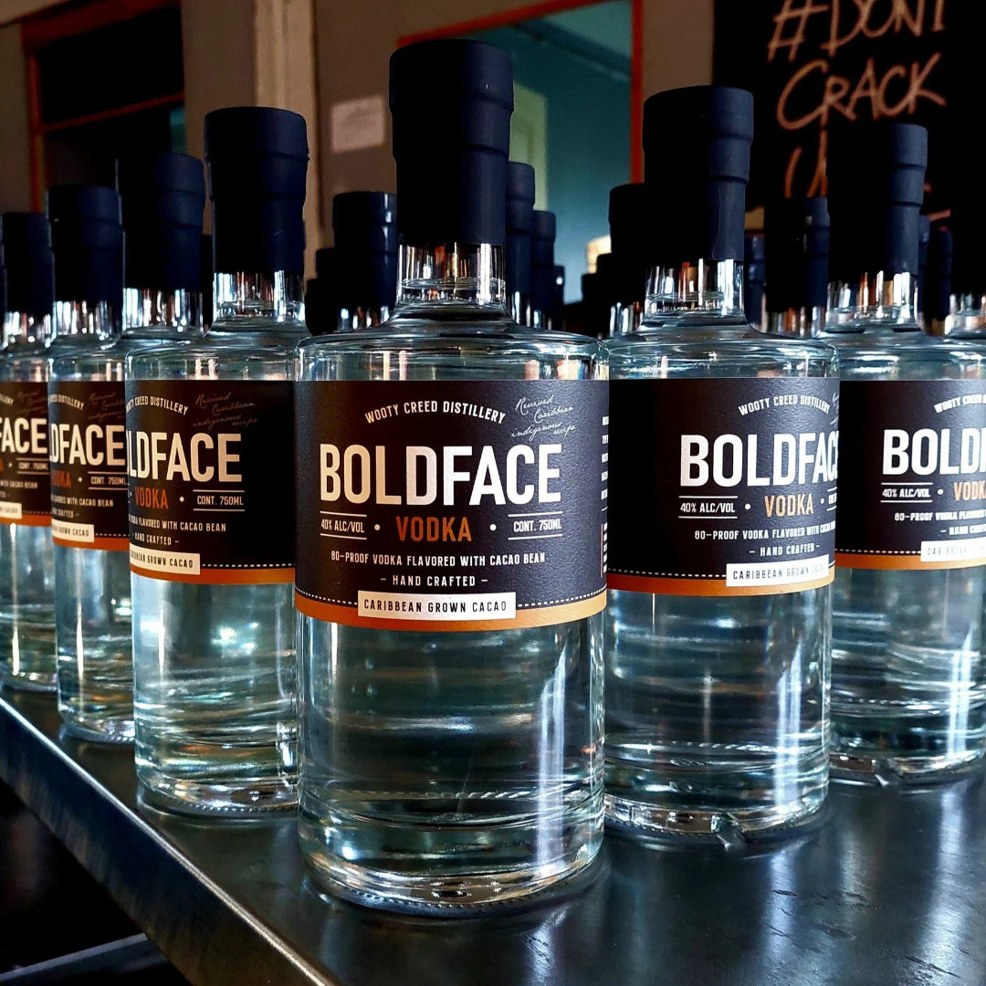 Row of Boldface Vodka bottles on a counter with a blurred background.