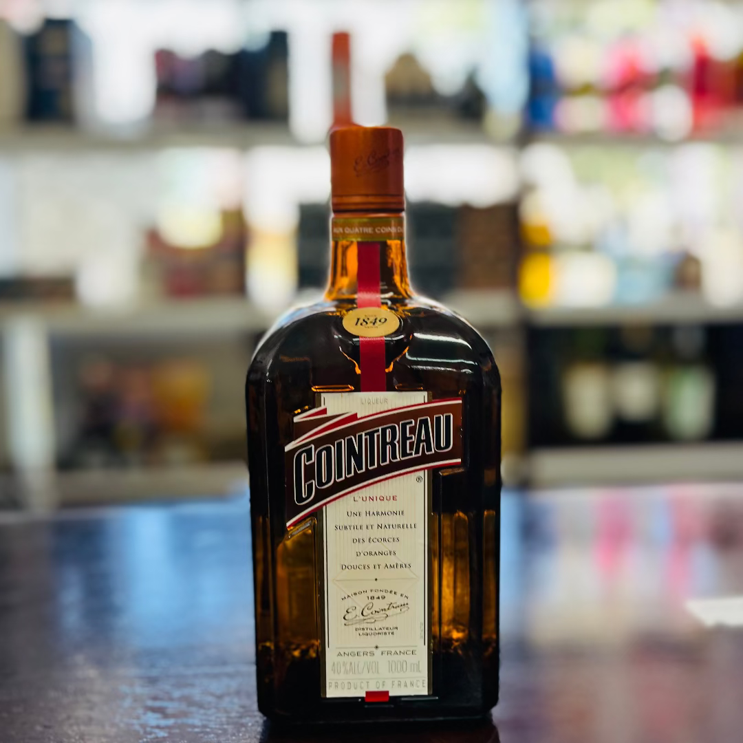 Bottle of Cointreau on a bar counter with a blurred bar background