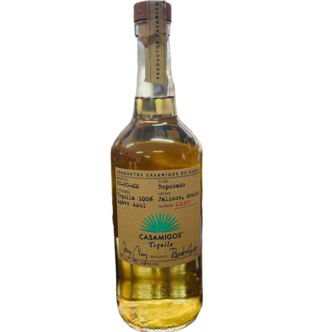 Bottle of Casamigos tequila on a bar counter with a blurred bar background