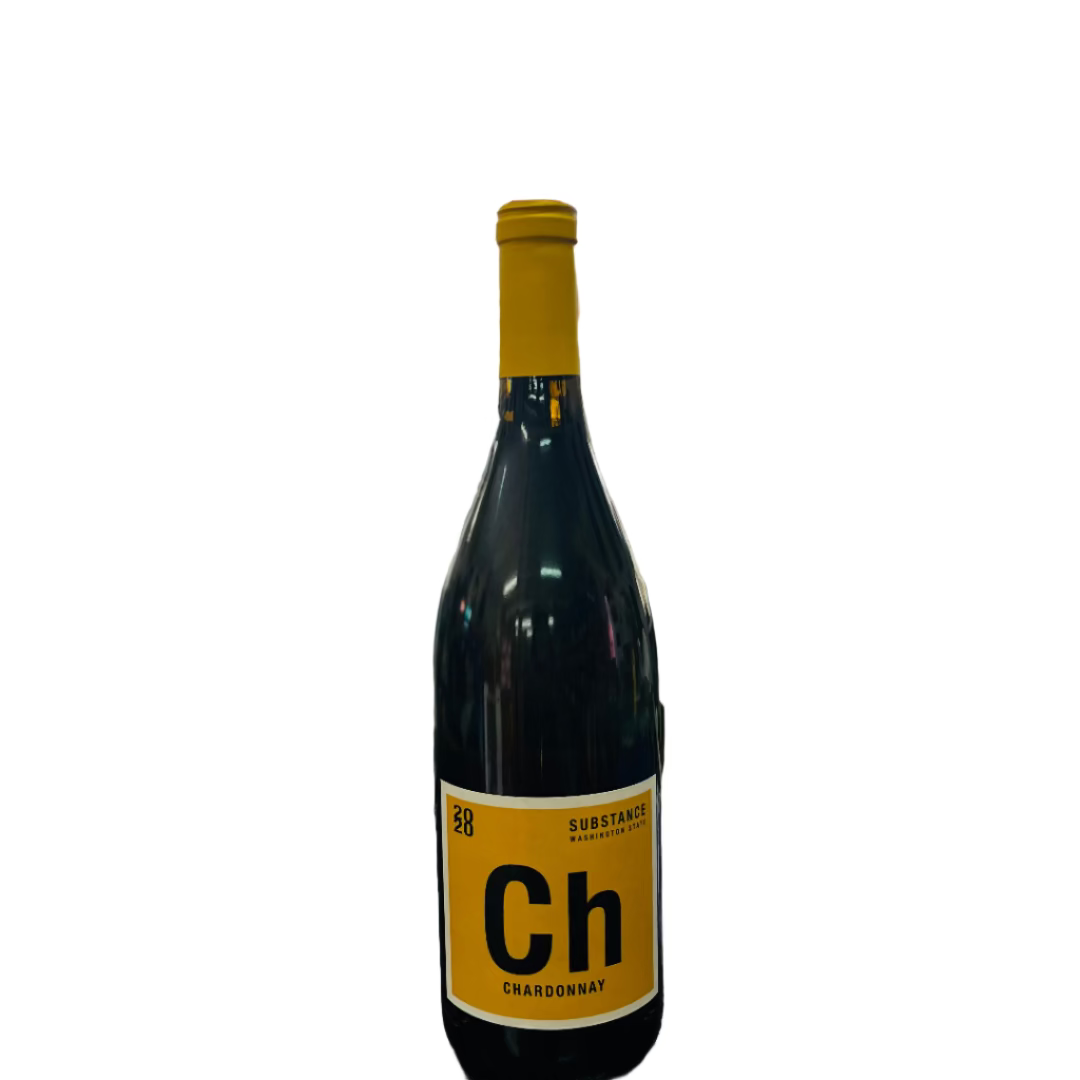 Wine bottle with yellow label featuring 'Ch' on a wooden surface with blurred shelves in the background.