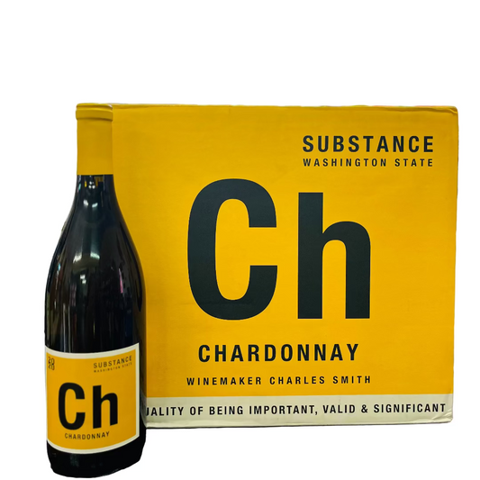 Bottle and box of Substance Chardonnay wine on a wooden surface with blurred shelves in the background.