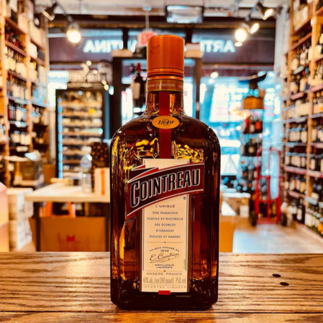 Cointreau bottle on a bar counter with a blurred bar background
