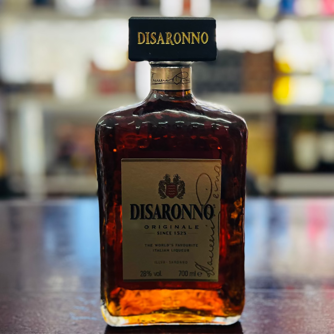 Bottle of Disaronno amaretto liqueur on a bar counter with a blurred bar background