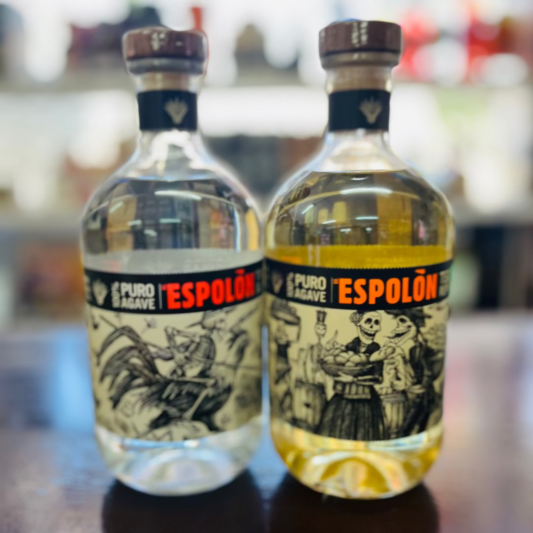 Two bottles of Espolón tequila on a bar counter with a blurred bar background.