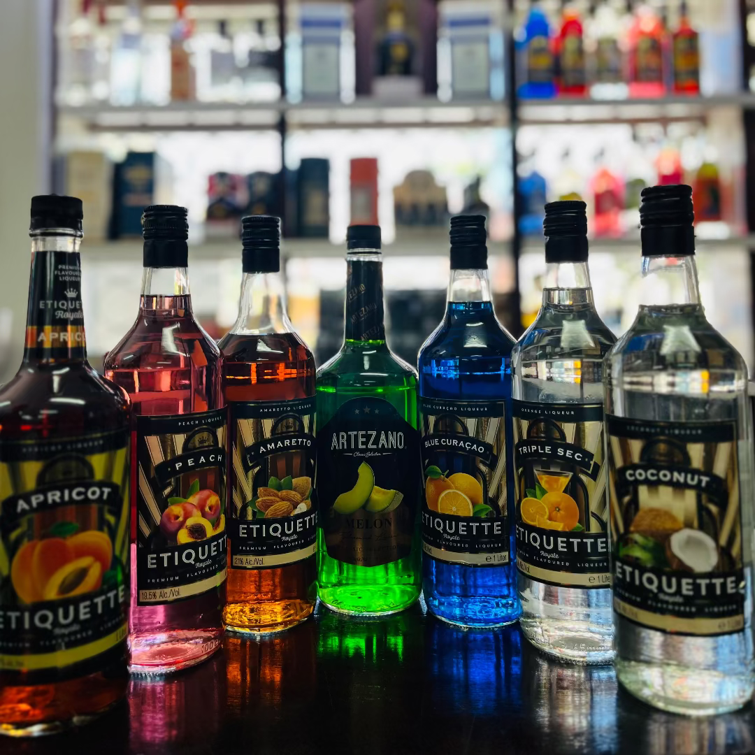 Row of Etiquette alcoholic beverages on a bar counter with a blurred bar background.