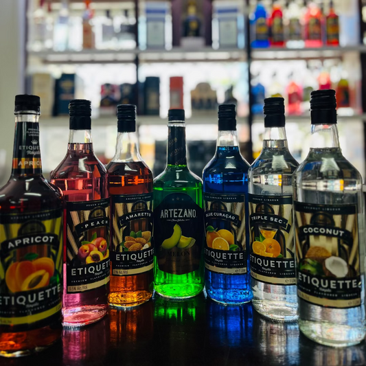 Row of Etiquette alcoholic beverages on a bar counter with a blurred bar background.