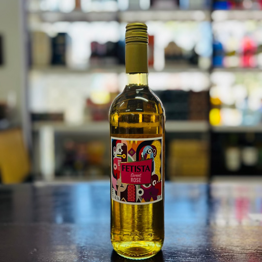 Bottle of white wine with a colorful label on a bar counter