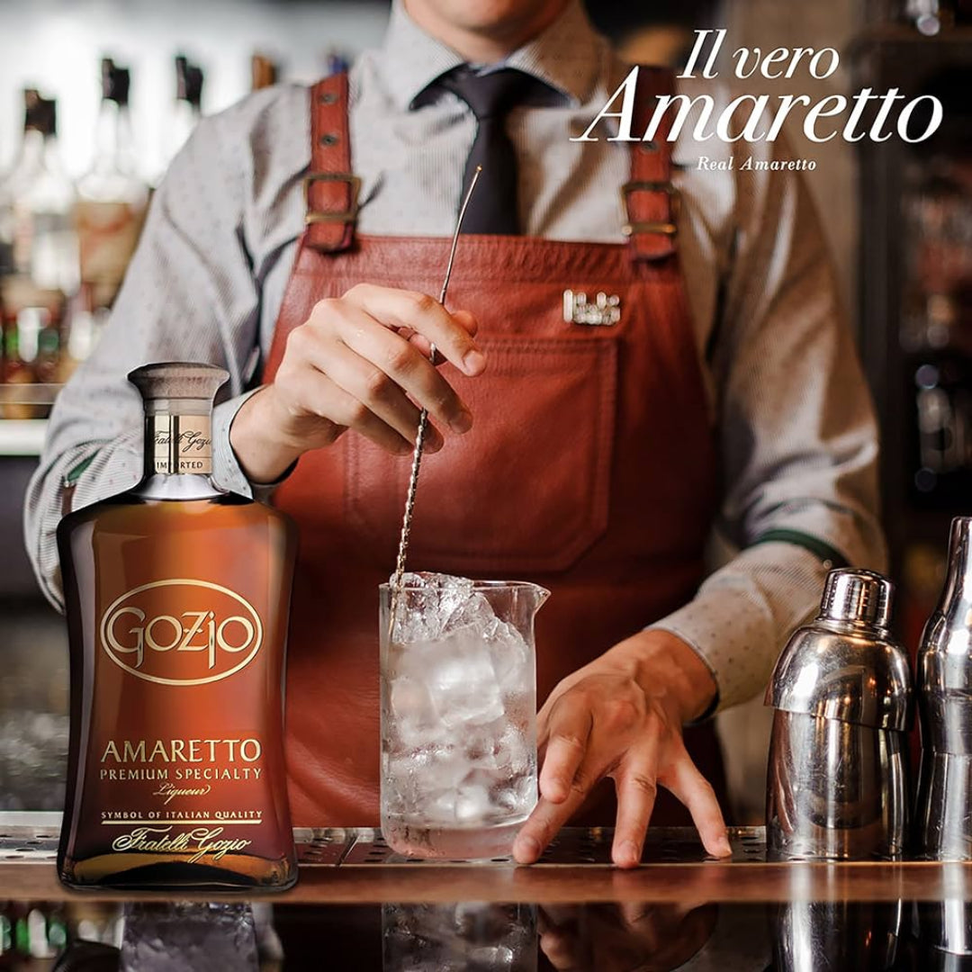 Bartender preparing a drink with Gozo Amaretto bottle in focus