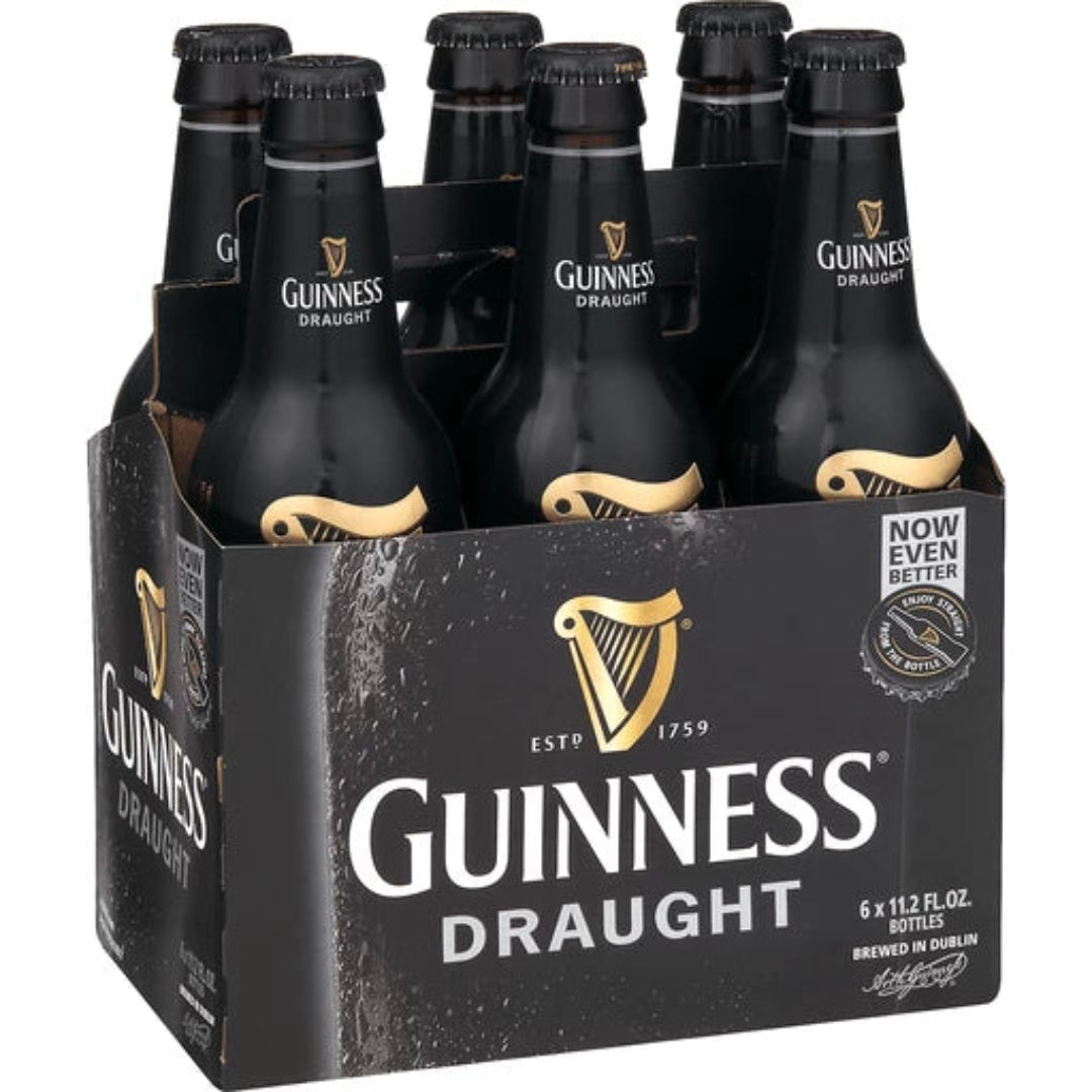 Pack of Guinness Draught beer bottles in a six-pack cardboard holder.