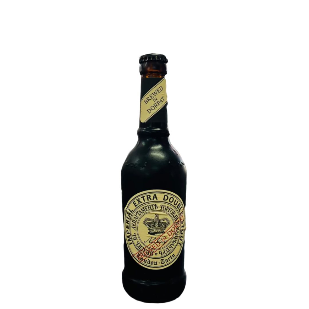 Bottle of Guinness Extra Stout on a wooden surface with a blurred store shelf in the background