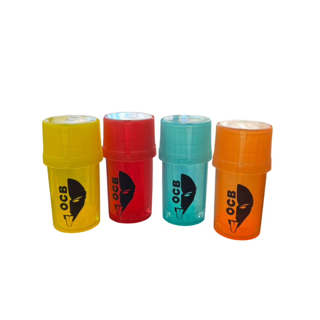 Four OCB rolling paper containers in yellow, red, green, and orange on a bar counter with bottles in the background.
