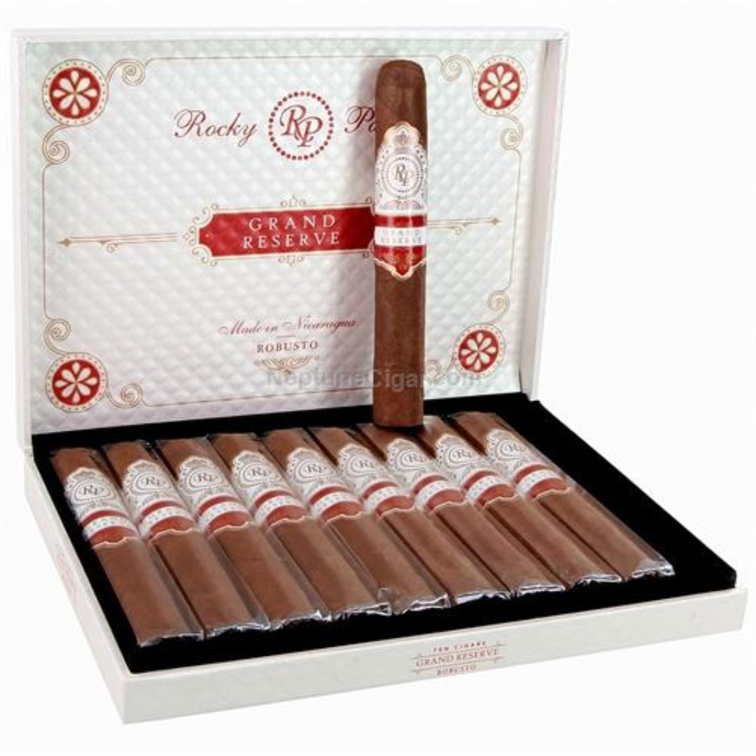 Open box of Rocky Patel Grand Reserve cigars with a single cigar on top