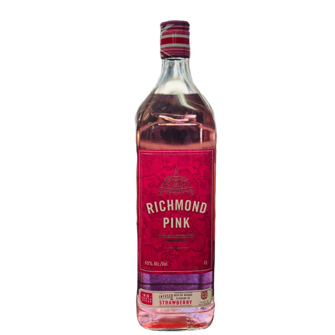 Bottle of Richmond Pink strawberry liqueur on a bar counter with a blurred bar background.