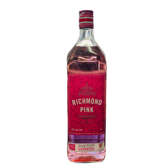 Bottle of Richmond Pink strawberry liqueur on a bar counter with a blurred bar background.