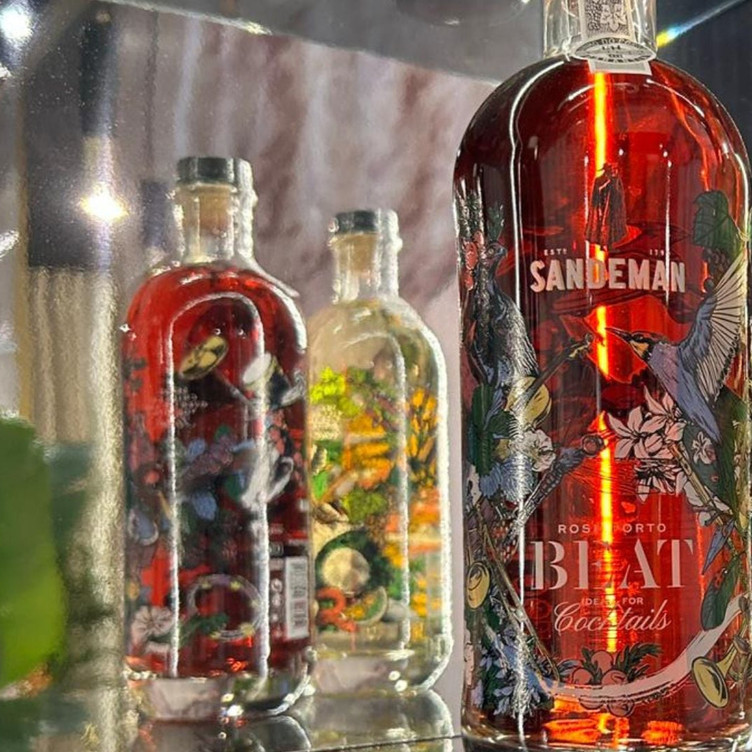 Three Sandeman brand bottles displayed against a dark background