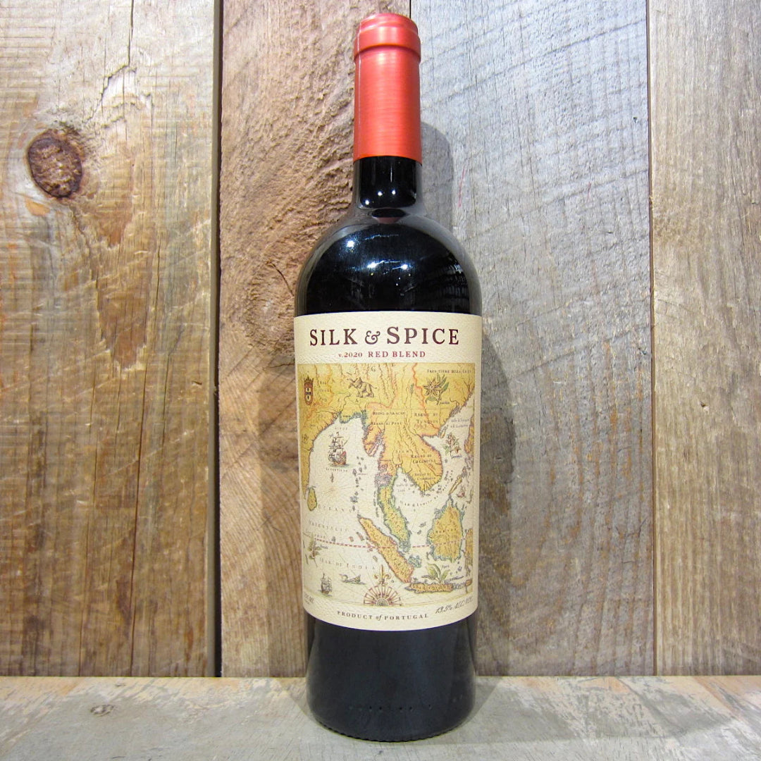 Bottle of Silk & Spice wine on a wooden surface
