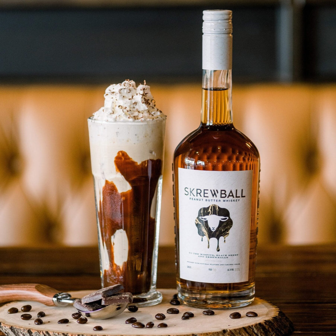 Skrewball whiskey bottle with a dessert on a wooden surface