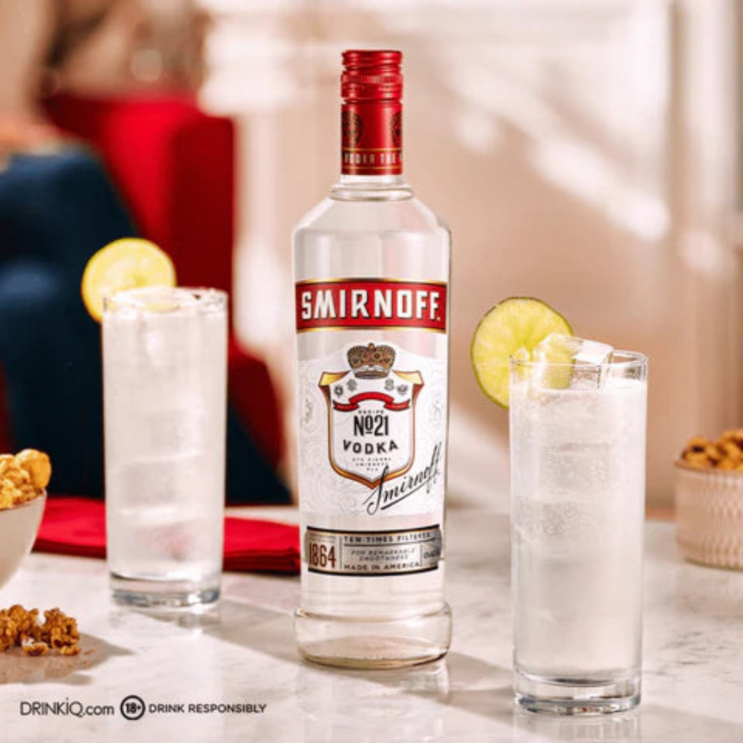 Smirnoff vodka bottle with two cocktails on a table