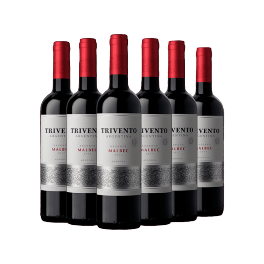 Six bottles of Trivento Argentine Malbec wine on a green background