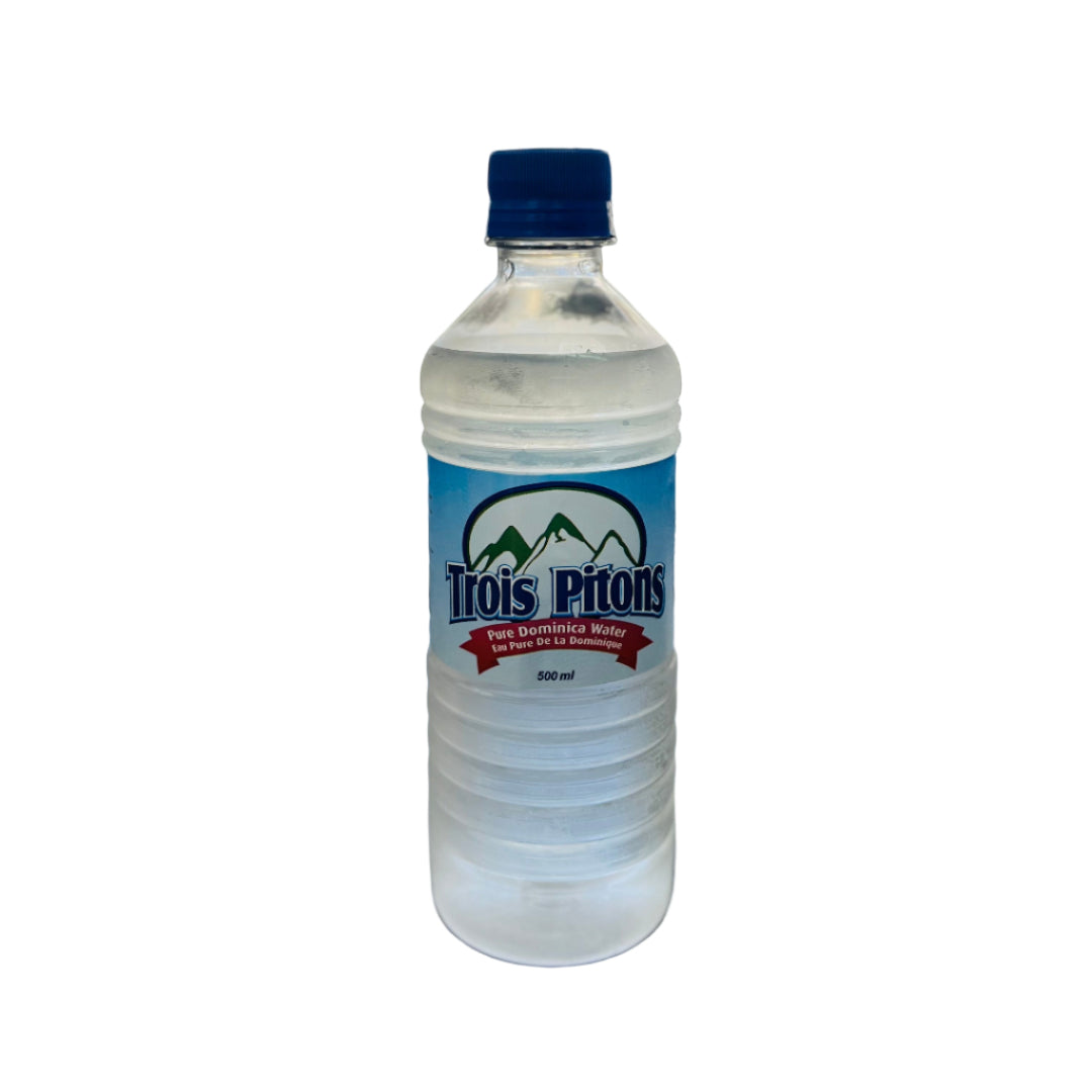 Bottle of Trois Pitons water on a dark surface with a blurred background