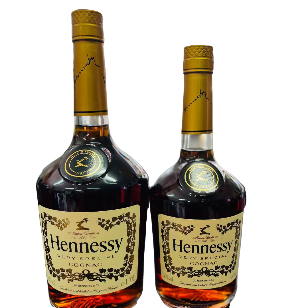 Two Hennessy bottles on a bar counter with a blurred bar background