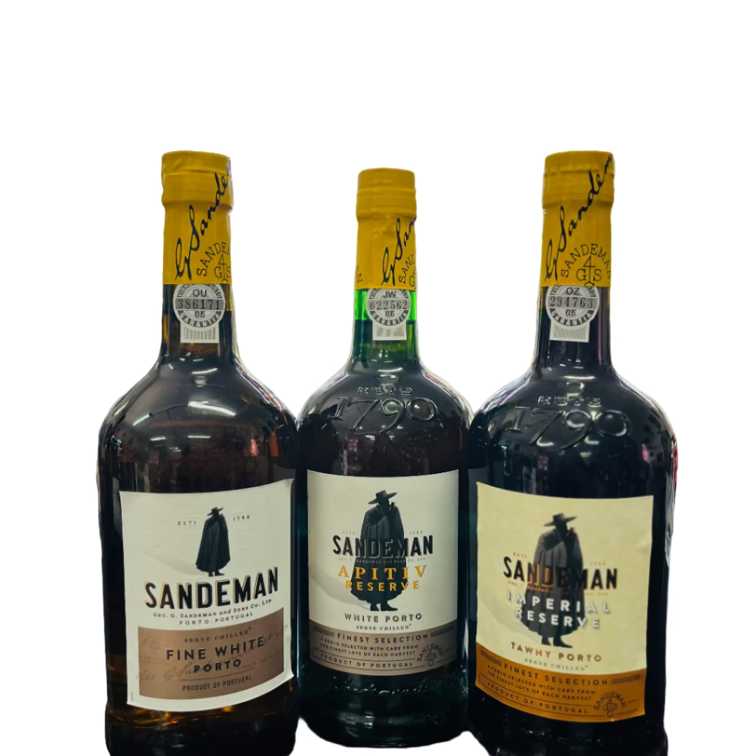 Three Sandeman port wine bottles on a bar counter with a blurred bar background.
